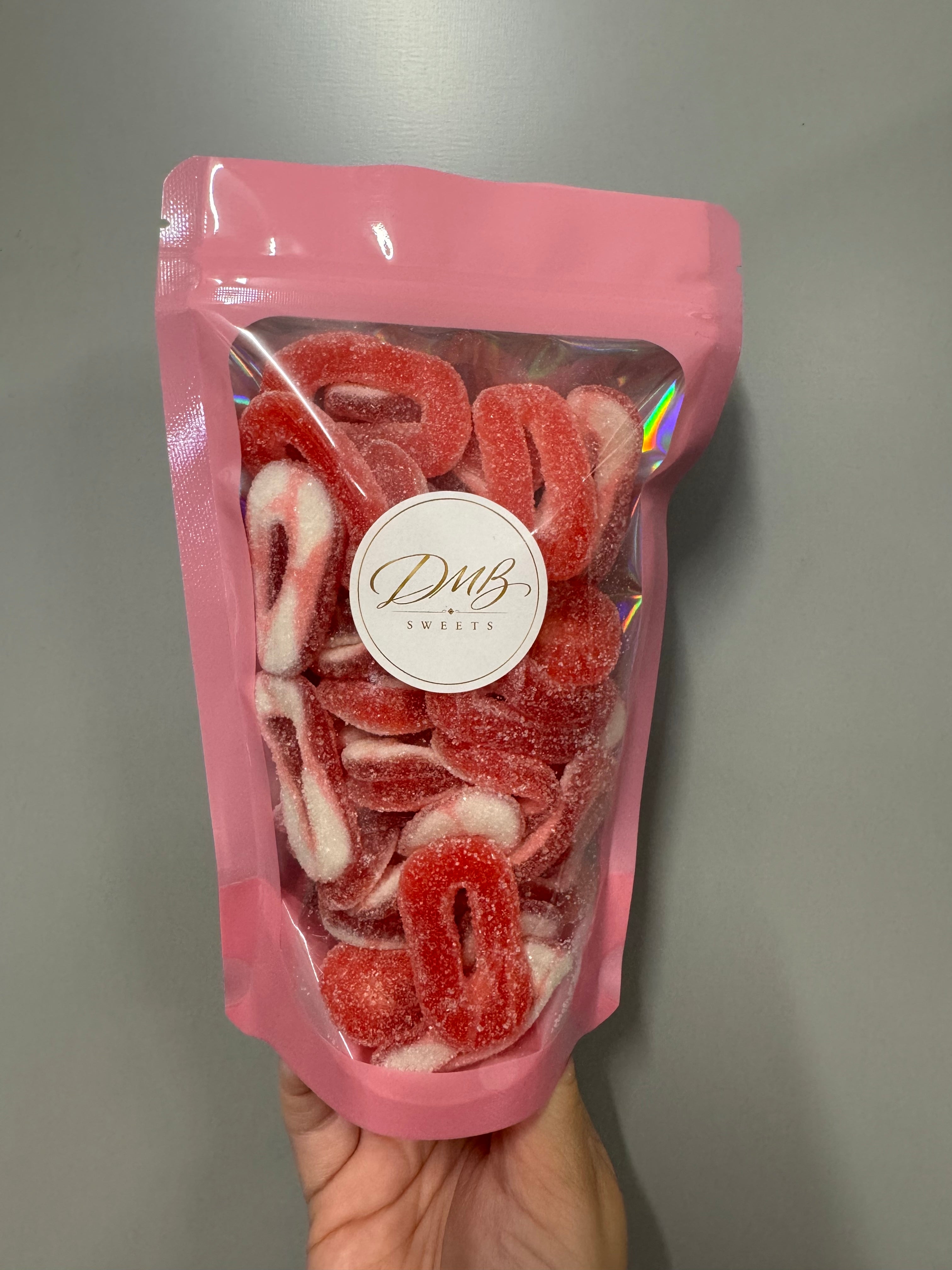 DMB Sweets Fizzy Strawberry Rings in a pink branded bag - illustration purposes only