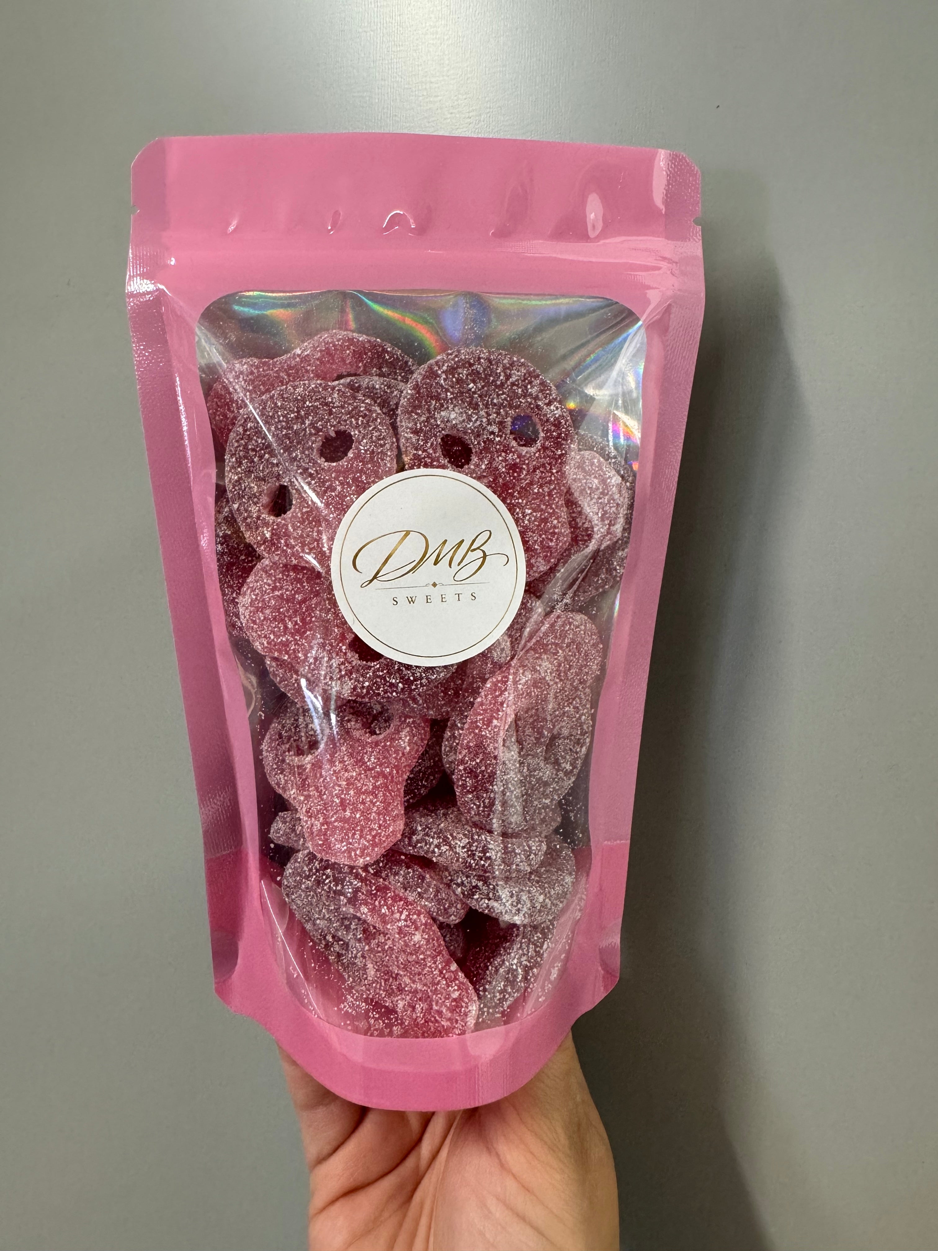 Cherry and Pomegranate Skulls 300g in a DMB Sweets pink pouch