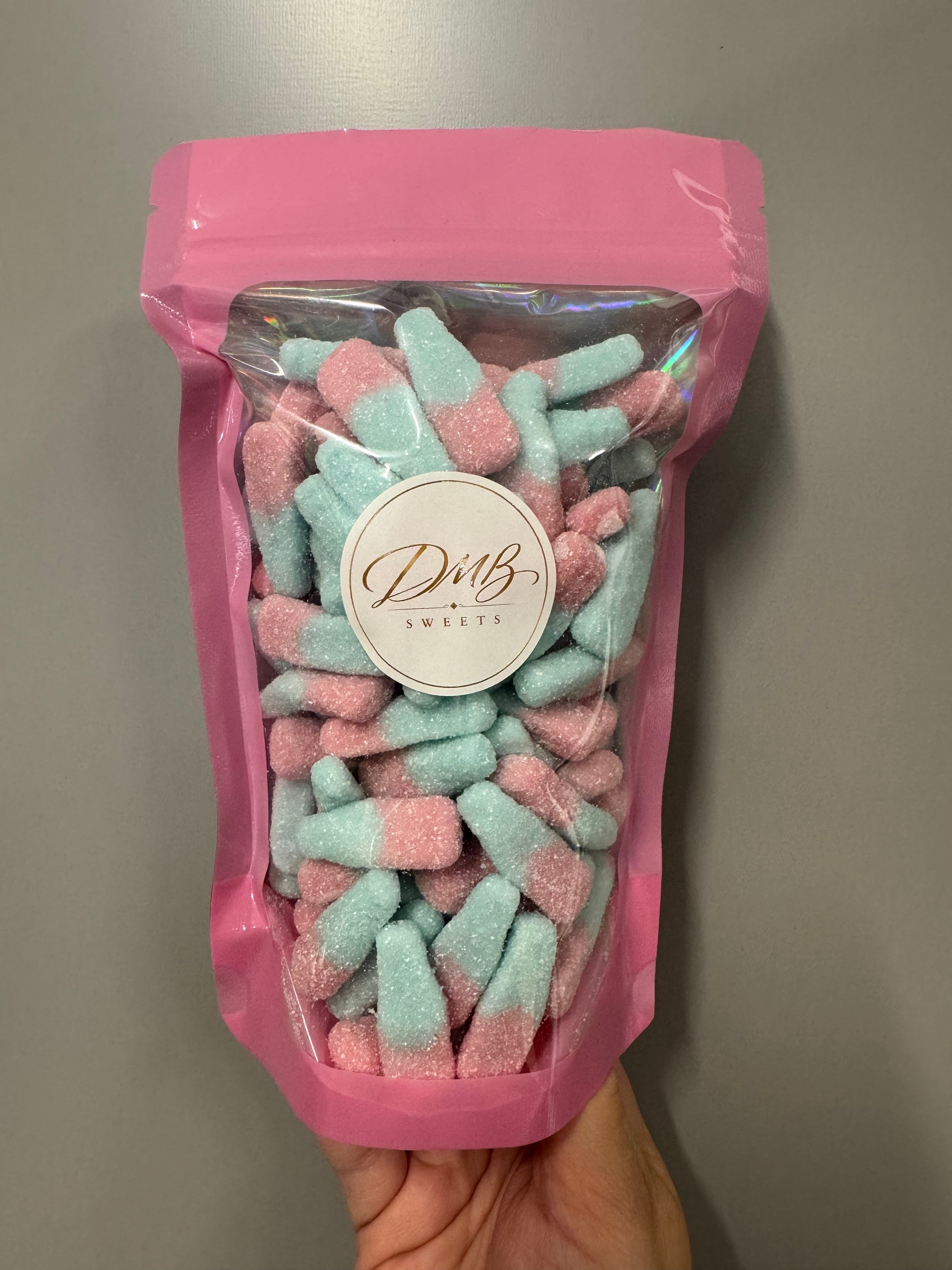 Tutti Frutti Bottles 300g in a DMB Sweets pink pouch